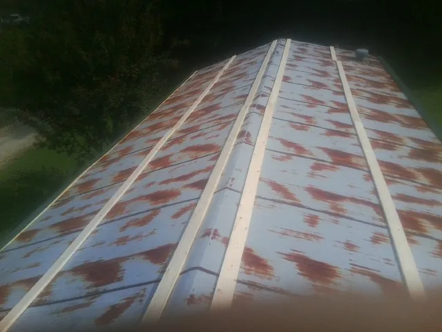 Rusted metal roof panels with new wood purlins before replacement — Storm Damage Roof Repair in Blackwood by Roofing Brothers